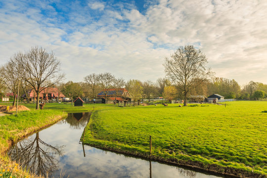 Burgemeester Bruins Slotsingel, Alphen aan den Rijn, Zuid Holland, Netherlands, April 12, 2019: Zegersloot petting farm and "de Schaapskooi" pancake farm against blue skies with clouds