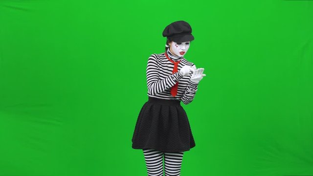 Mime woman is having call, talking. Green screen, Chroma key.