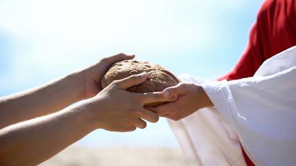 Jesus hands giving bread to poor man, biblical story to feed hungry, charity - 290836118