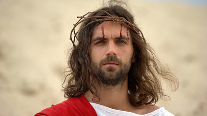 Drops of blood running down Jesus face, God looking on camera, crucifixion