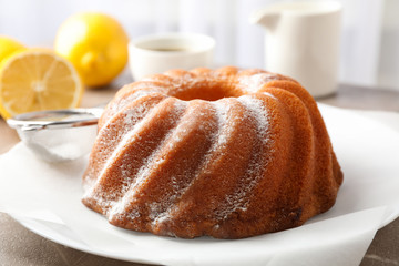 Cake with powder sugar on grey table, close up