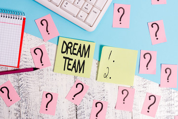 Conceptual hand writing showing Dream Team. Concept meaning Prefered unit or group that make the best out of a demonstrating Writing tools and scribbled paper on top of the wooden table