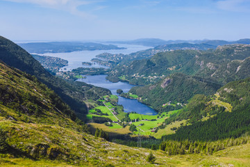 Naklejka premium tourist hiking on a sunny summer day on the nature of mountain norway