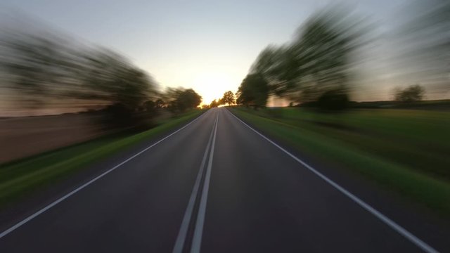 On a rural road to sunset, time-lapse