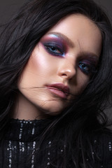 Fototapeta premium Beautiful sexy girl with professional evening makeup, perfect shining skin. Trendy colorful smoky eyes.