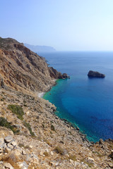 Photo of picturesque Monastery of Panagia Hozoviotissa built on a steep cliff with view to Aegean...