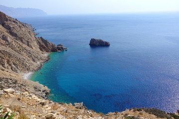 Photo of picturesque Monastery of Panagia Hozoviotissa built on a steep cliff with view to Aegean deep blue, Amorgos island, Cyclades, Greece