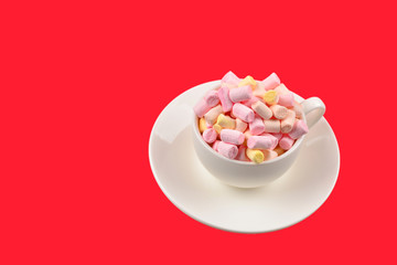 Fototapeta na wymiar Cup with marshmallow on a red background. Copy space.