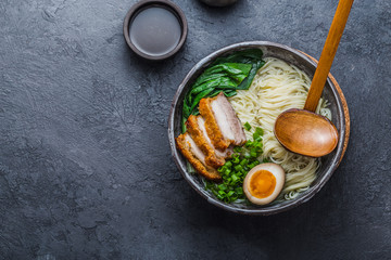 Ramen bowl with pork, pak choi and egg, copy space