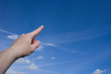 Pointing into blue sky with a few clouds