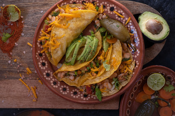 Vegetarian soft tacos served on a traditional Mexican clay plate