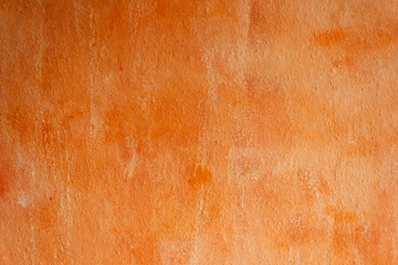 Orange painted wall. Textured paint on the wall.
