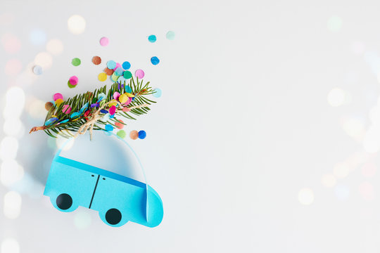 Christmas And New Year Holiday Card. Blue Paper Car With Christmas Tree Over White Background