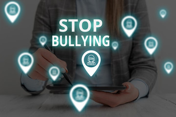 Text sign showing Stop Bullying. Business photo text Fight and Eliminate this Aggressive Unacceptable Behavior Woman wear formal work suit presenting presentation using smart device
