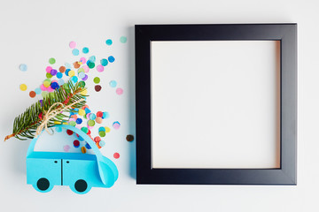 Christmas and New Year holiday card. Blue paper car with christmas tree over white background