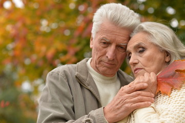 Portrait of sad senior couple in park