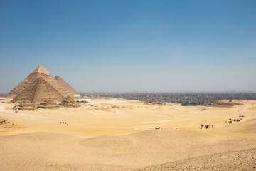 Fototapeta na wymiar The Giza pyramid complex, also called the Giza Necropolis and Cairo Behind
