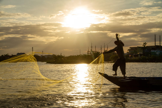 Man Net Fishing At Sunset, Hoi An, Vietnam