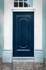 Dark blue wooden door without knob