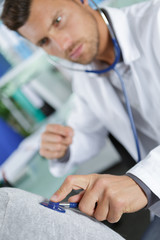 doctor examining the patients breathing