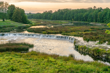 Fototapeta na wymiar Beautiful view of Rumba waterfall in Kuldiga in the early morning. Tourist place in Latvia.