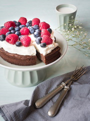 Cake made from chocolate and chestnut puree with fresh fruits on the top.