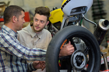 Fototapeta na wymiar two mechanics in a motorbike garage