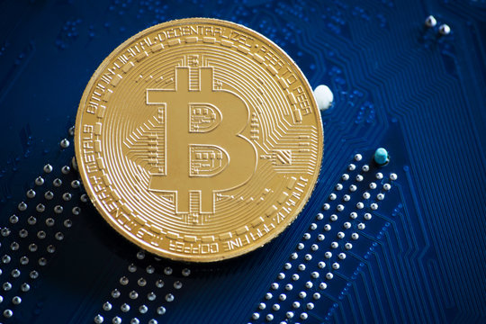 coin with bitcoin logo on computer parts. bussines of cryptocurrency background