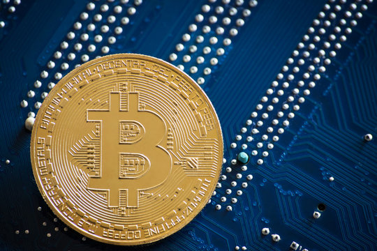 coin with bitcoin logo on computer parts. bussines of cryptocurrency background