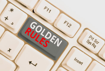 Writing note showing Golden Rules. Business concept for Basic principle that should be followed Important Principle White pc keyboard with note paper above the white background