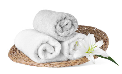 Fototapeta na wymiar Wicker tray with towels and flower isolated on white. Spa treatment