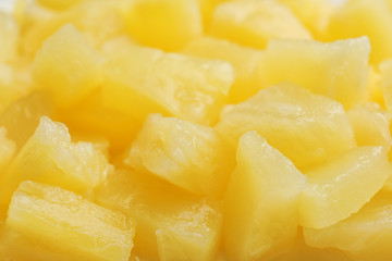 Pieces of delicious sweet canned pineapple as background, closeup