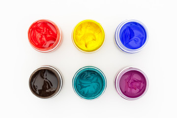 Set of gouache paint pots of different colors top view on isolated white background