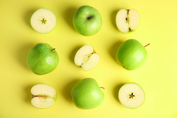 Flat lay composition of fresh ripe green apples on yellow background