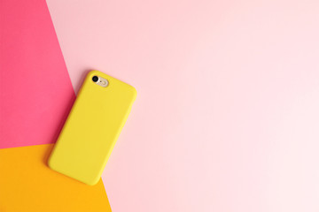 Modern phone on color background, top view. Space for text