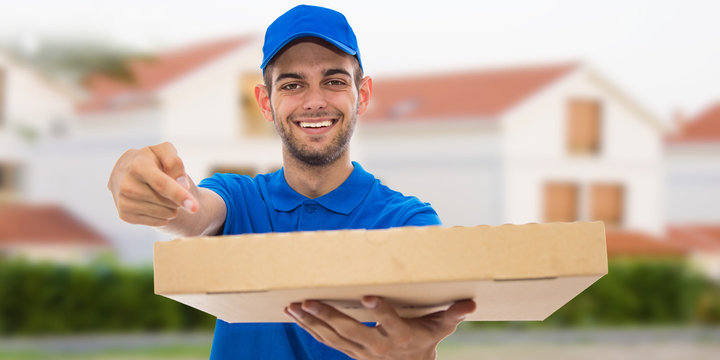 smiling pizza delivery man with pizza boxes and houses - Powered by Adobe