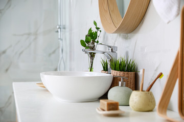 Modern bathroom interior with vessel sink and decor elements