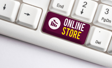 Writing note showing Online Store. Business concept for A website that offers items for sale and accept credit cards White pc keyboard with note paper above the white background