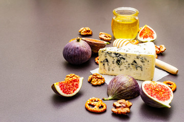 Cheese appetizer selection or wine snack set. Blue cheese, figs, honey, walnuts, pretzels