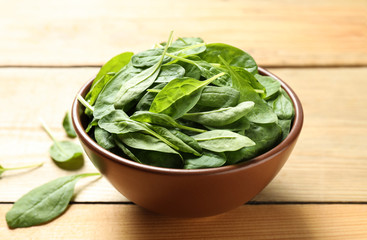 Fresh green healthy spinach on wooden table