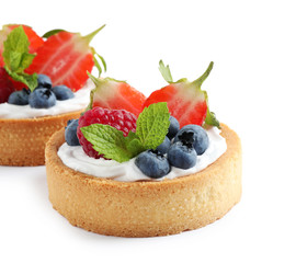 Delicious sweet pastries with berries on white background