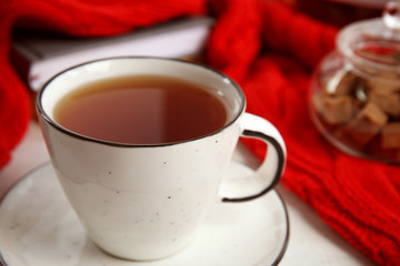 Cup of hot tea on table, closeup. Winter drink