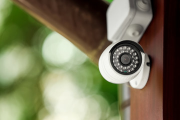 Modern CCTV security camera on building outdoors. Space for text