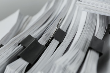Pile of documents with binder clips, closeup