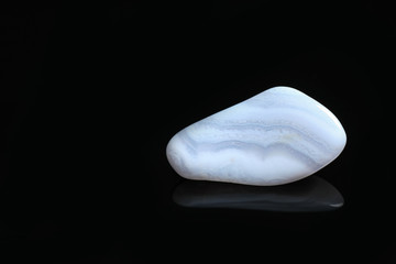 Beautiful blue agate gemstone on black background. Space for text