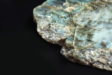 Beautiful labradorite gemstone on black background, closeup