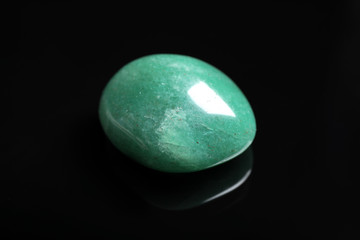 Beautiful green aventurine gemstone on black background