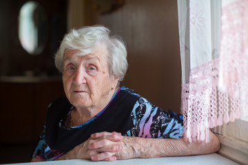 Portrait of a gray-haired old elderly woman.