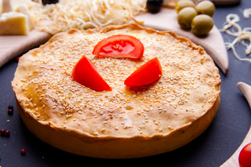 Fresh Traditional Australian meat mini pie on the wooden board on table background, closeup with copy space, top view, rustic style