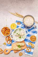 Oktoberfest set. Dark beer, weisswurst, pretzels, mustard, spikelets of grain, hop